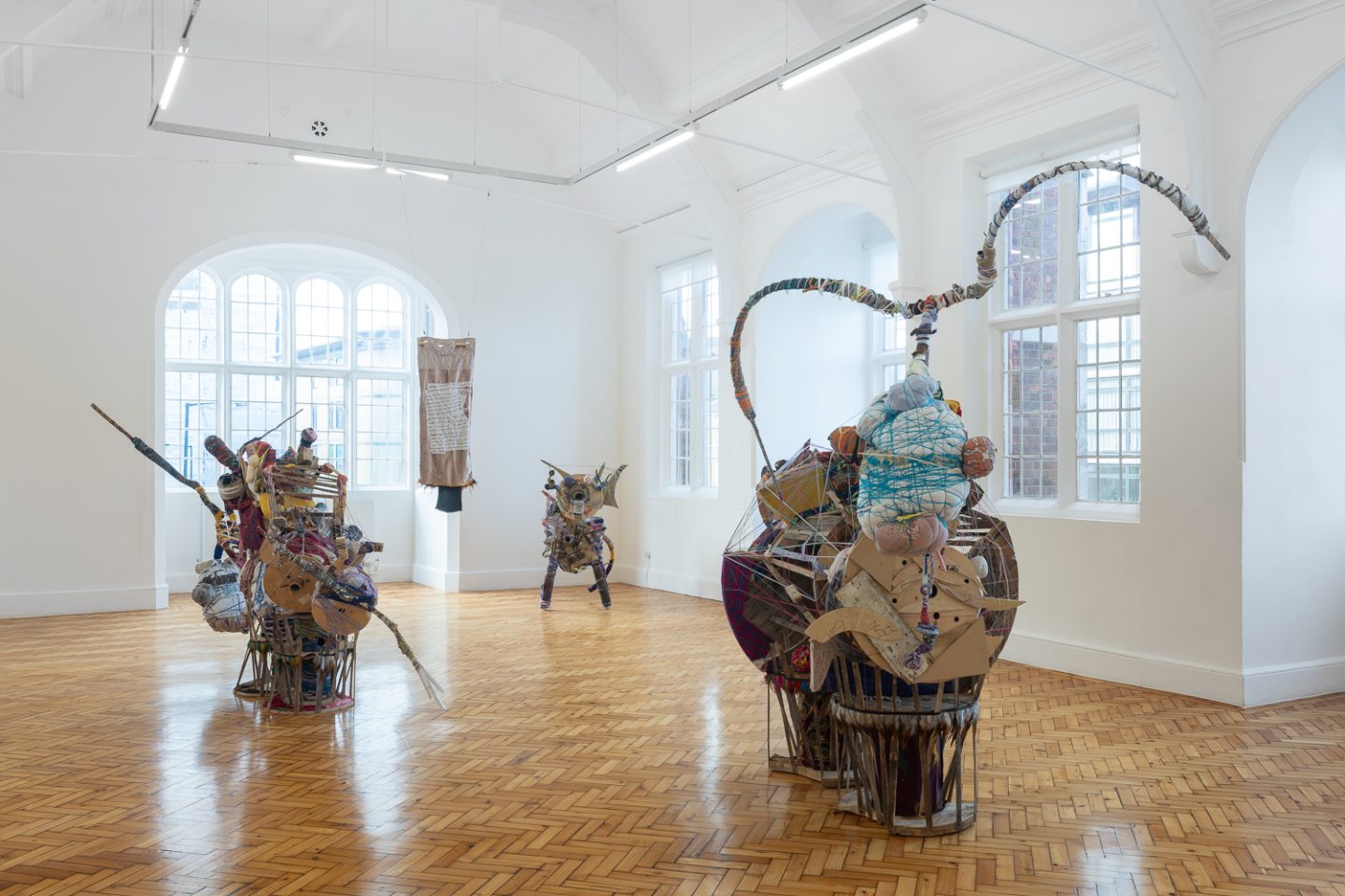 Installation view of three large sculptures made out of a range of materials.