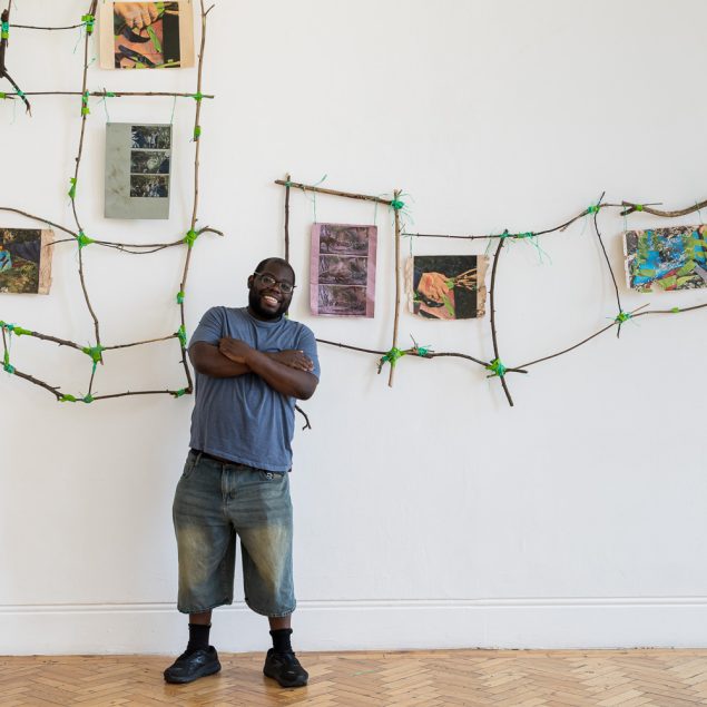 Immanuel stands in front of the installation at Camden Art Centre.