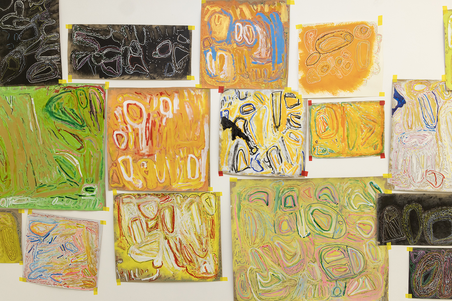 A wall coverted in drawings by Chandrakant Patel in a variety of different sized rectangles and squares
