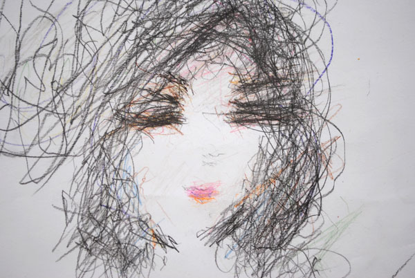 Close up detail of a drawing of a female face.