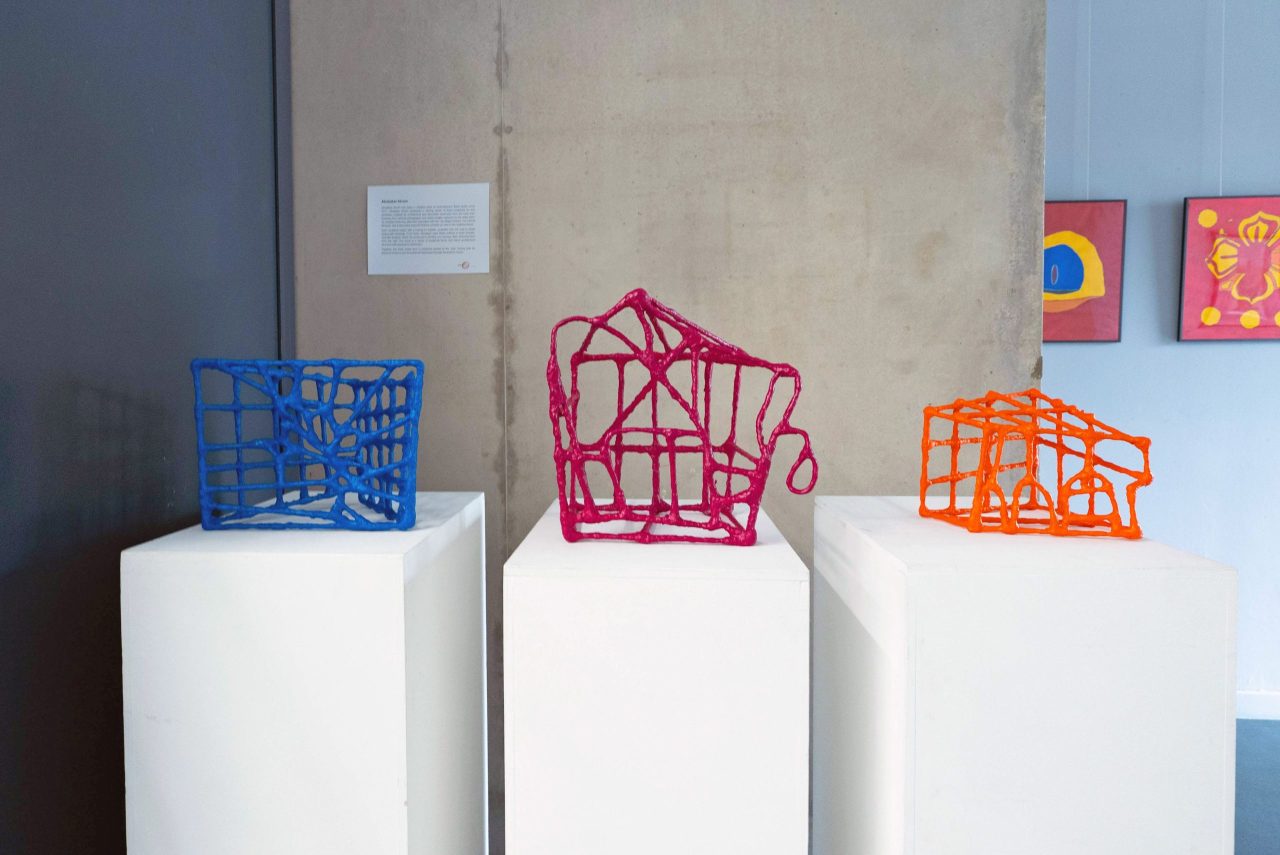 Three small sculptures with thick constructed lines in an abstract shape.