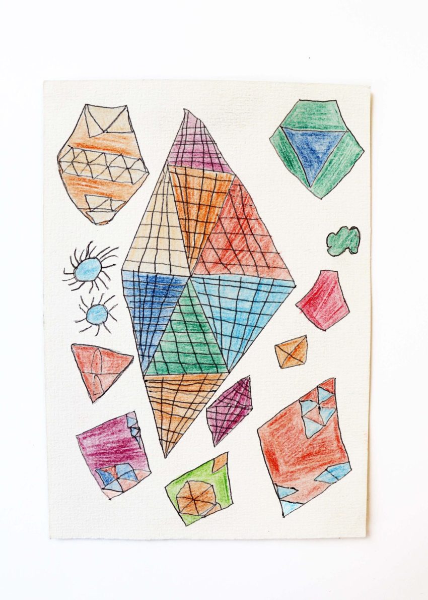 A small colourful, pencil drawing on paper with angular shapes and grid like hatching marks.