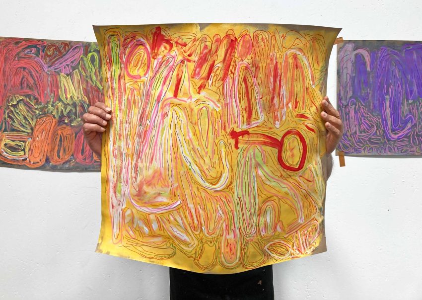 Chandrakant Patel holding orange painting, 2025. Image courtesy of the Artist and ActionSpace.