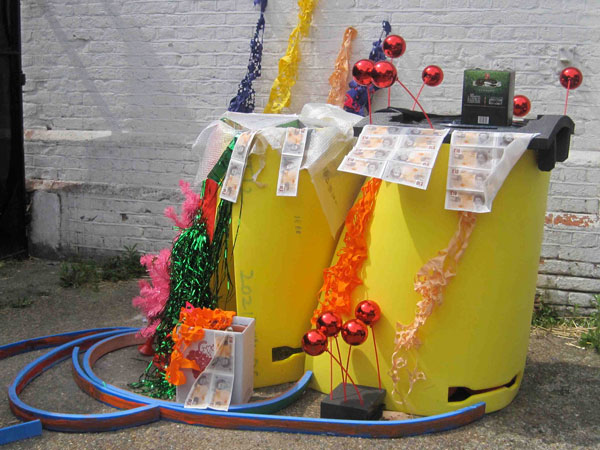 Sculpture made up of ready made objects such as print out money, christmas decorations, tinsel and foam.
