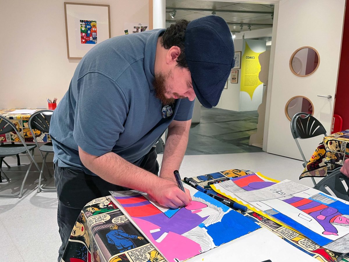 Evan Bond with his artwork. Image courtesy of ActionSpace and the Artist.