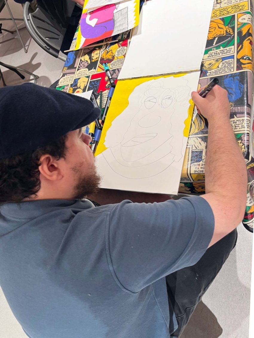 Evan Bond with his artwork. Image courtesy of ActionSpace and the Artist.