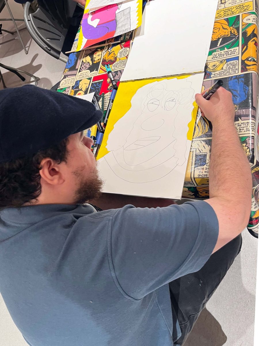 Evan Bond with his artwork. Image courtesy of ActionSpace and the Artist.