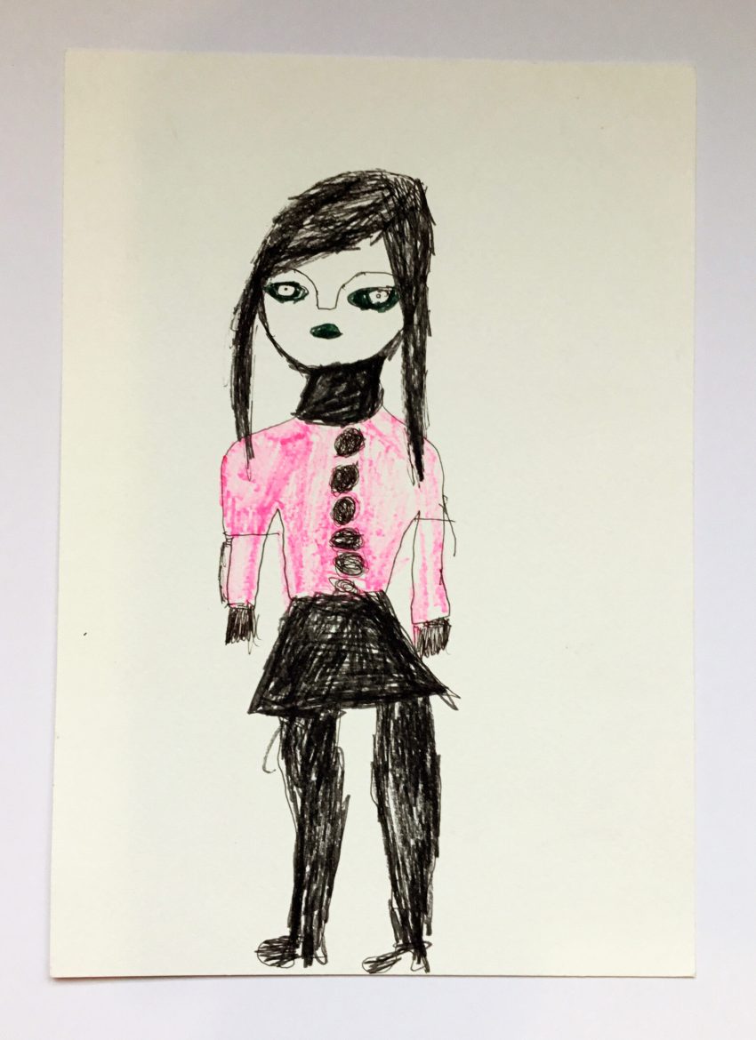 A drawing of a woman with dark hair wearing a pink jacket and black skirt, in pen on paper.