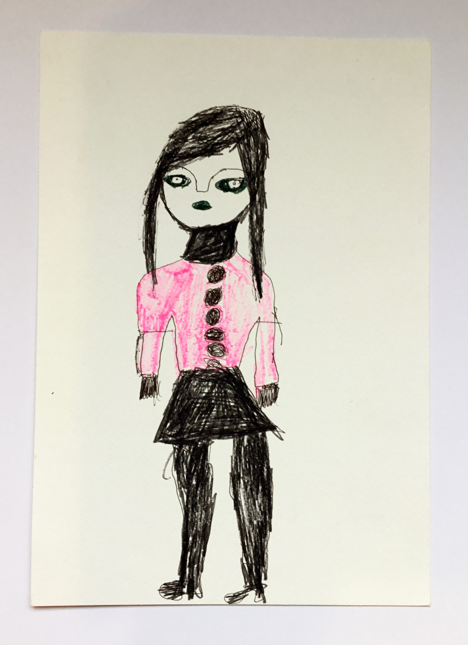 A drawing of a woman with dark hair wearing a pink jacket and black skirt, in pen on paper.