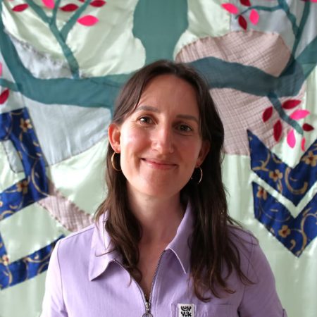 A picture of Anna Skulczuk. She is a white woman with long dark hair and is wearing a lilac coloured top.