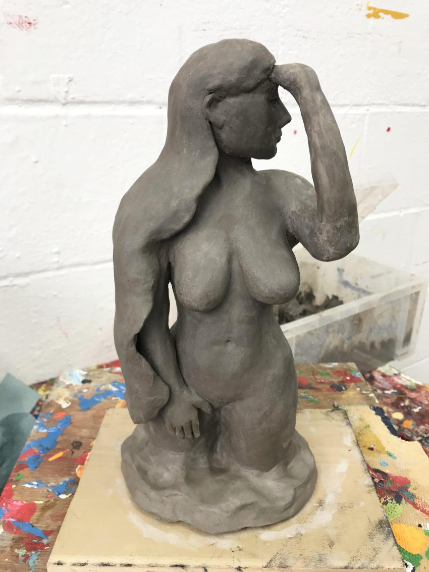 A sculpture of a nude female form.