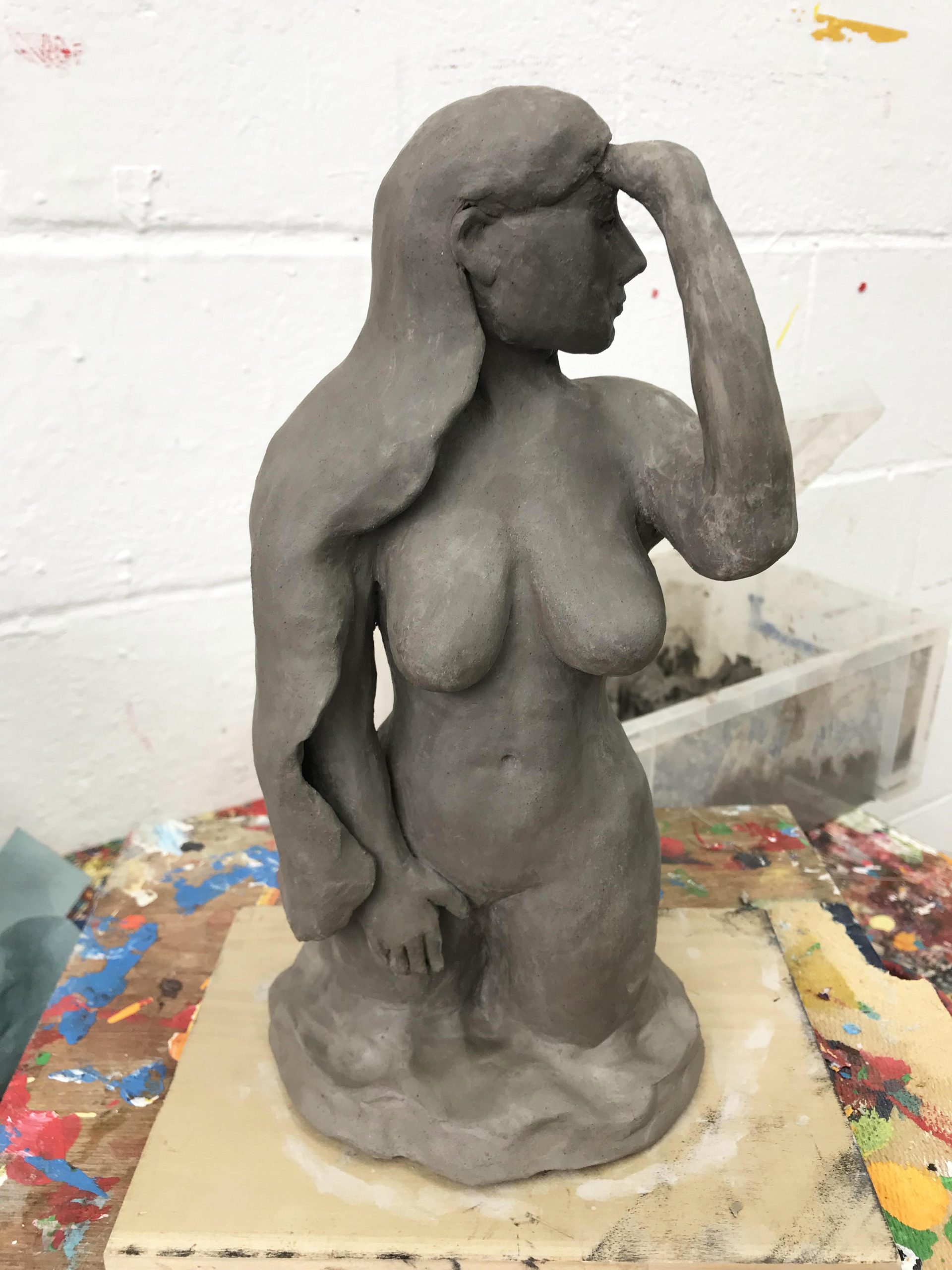 A sculpture of a nude female form.