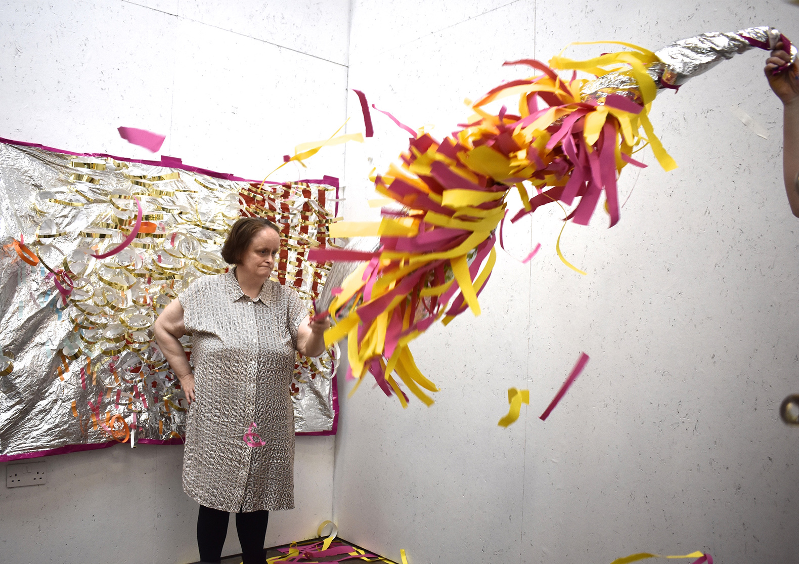 Linda Bell demonstrating how to use one of her sculptures.