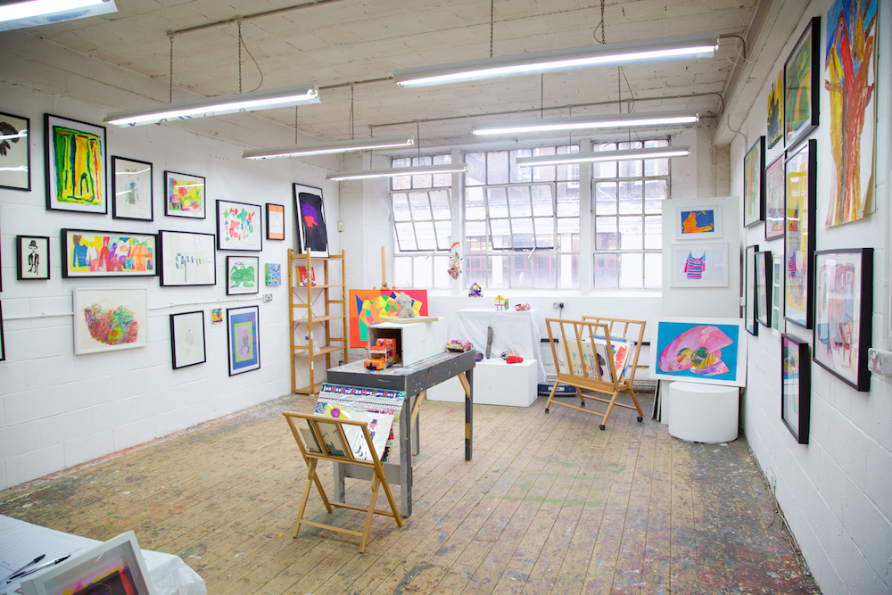Cockpit studio, with framed artworks of different artists on the wall.