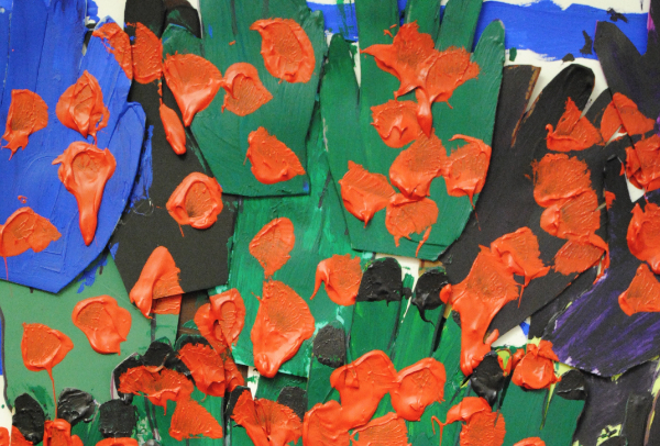 paper is cut out into the shape of hands, and painted green and blue. Over the top a lot of red dots are painted over the hands.