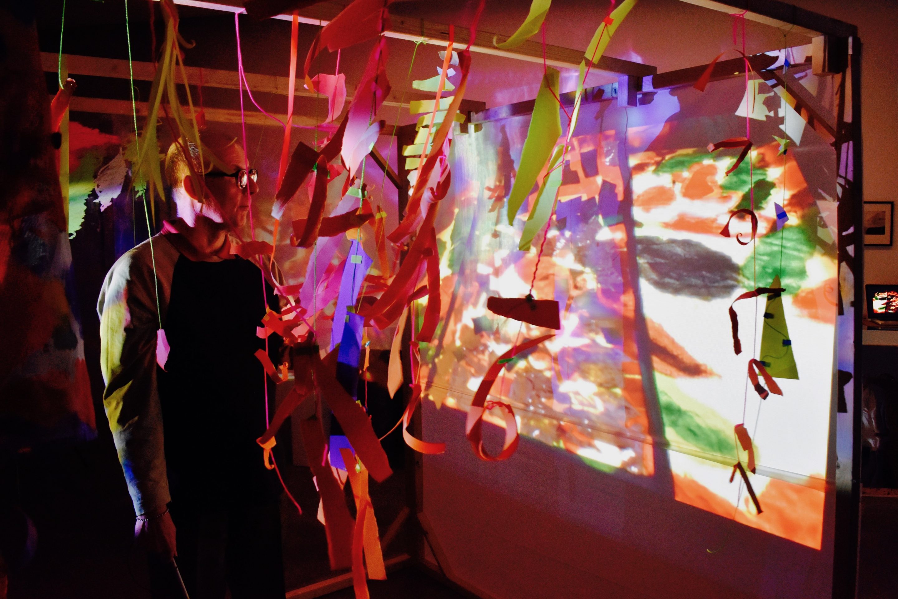 Artist Mark Lawrence stood beside his projection installation at Autograph Gallery.