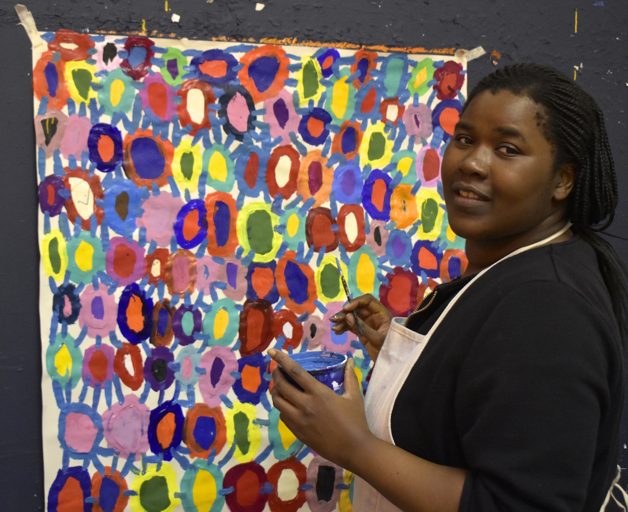 Kwaga Sillingi painting at the ActionSpace South London studio. Image courtesy of the Artist and ActionSpace
