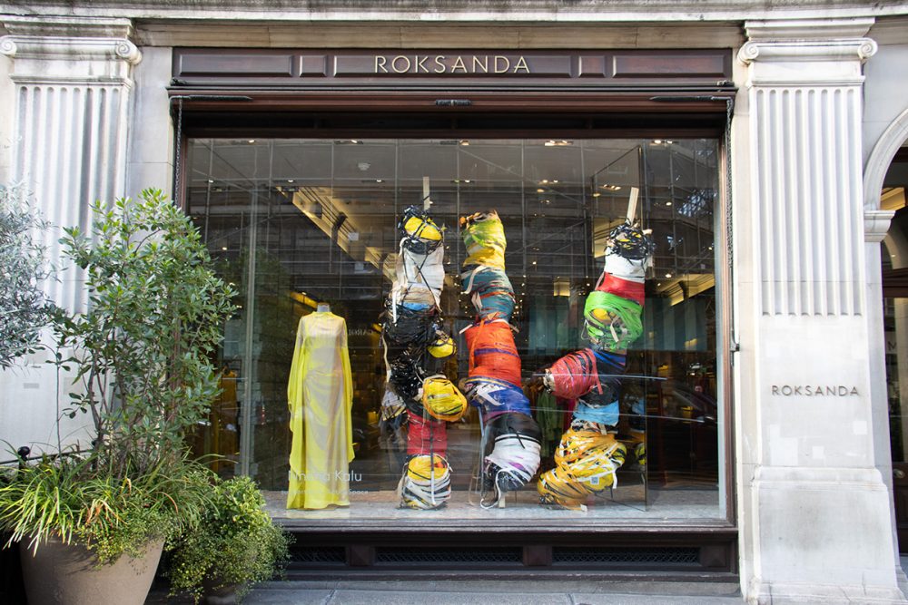 Nnena Kalu's sculptural work is displayed in the window of a clothes stop, with a yellow dress from ROKSANDA positioned next to 3 of Nnena's large, bound sculptures.