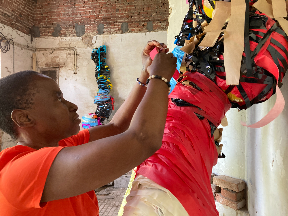 Nnena Kalu with her artwork. Image courtesy of ActionSpace. 