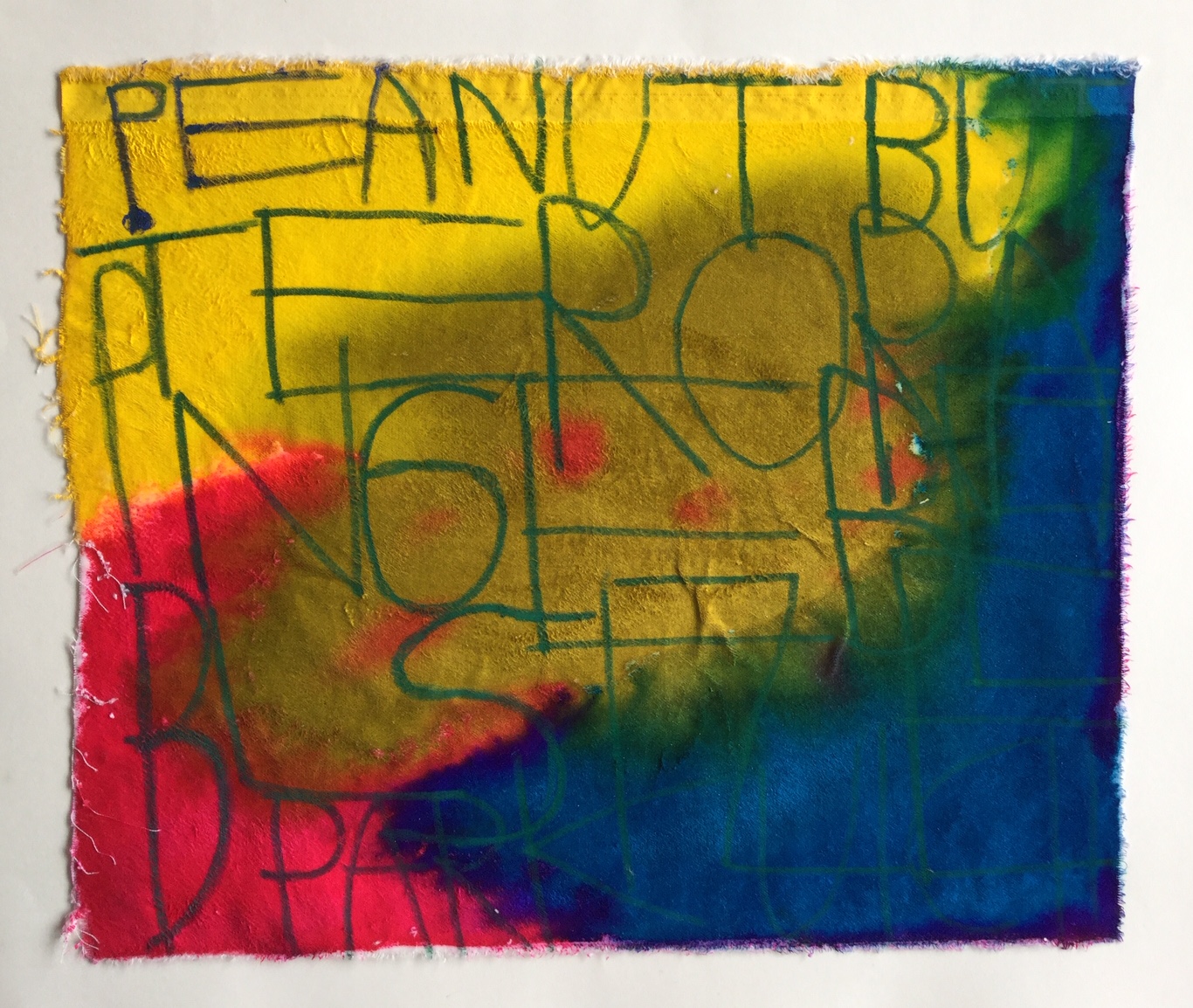 Rectangle shaped fabric coloured with bright inks that bleed into one another. Text written on top of the ink.