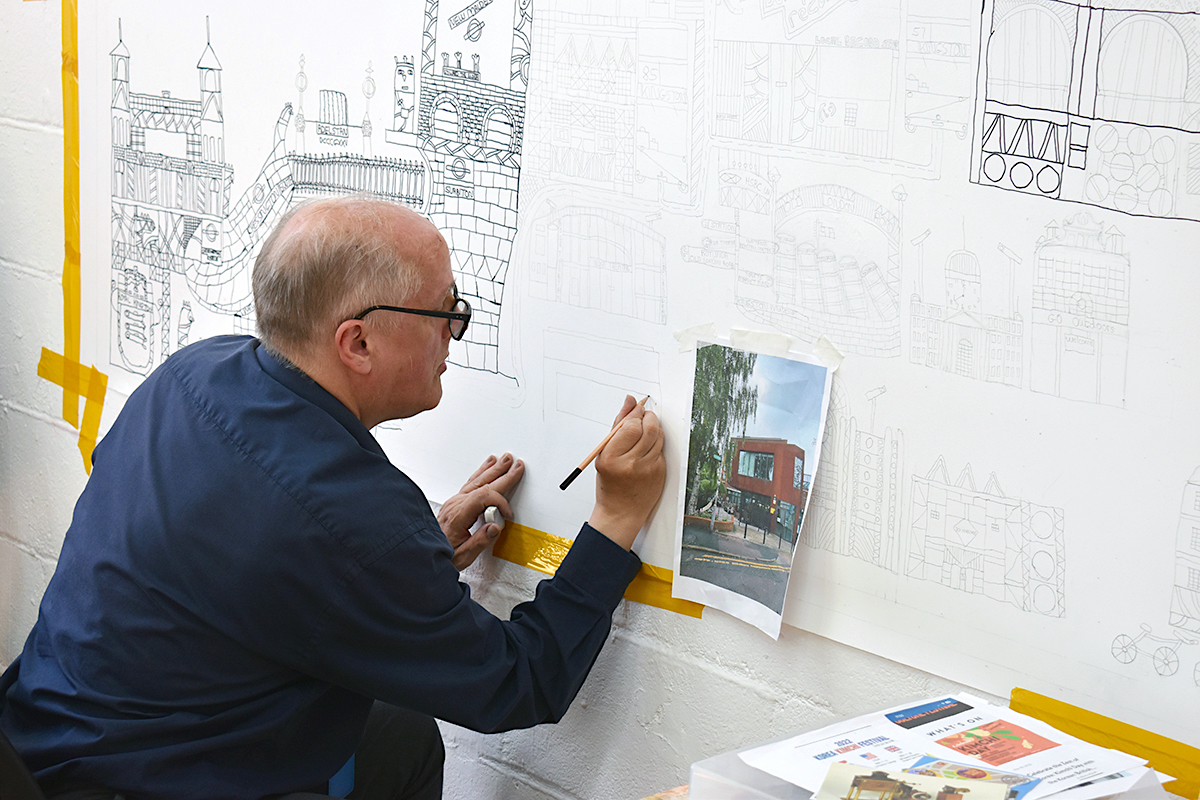 Artist Ian Wornast wokring on the sketch of an artwork.