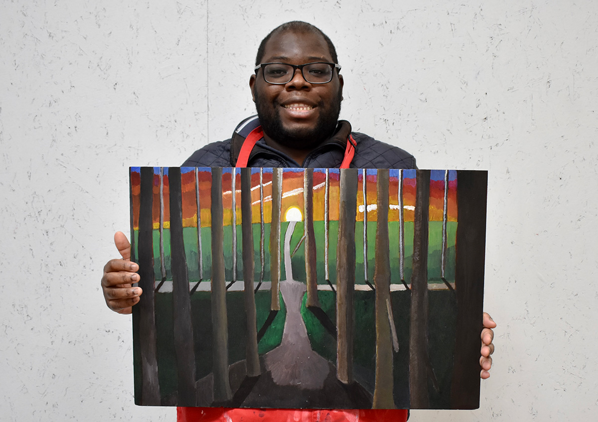 Immanuel Adelowo holding his artwork, Into The Depths (2024), acrylic paint on board, 64.5 x 44.5 cm, 2025. Image courtesy of the Artist and ActionSpace.