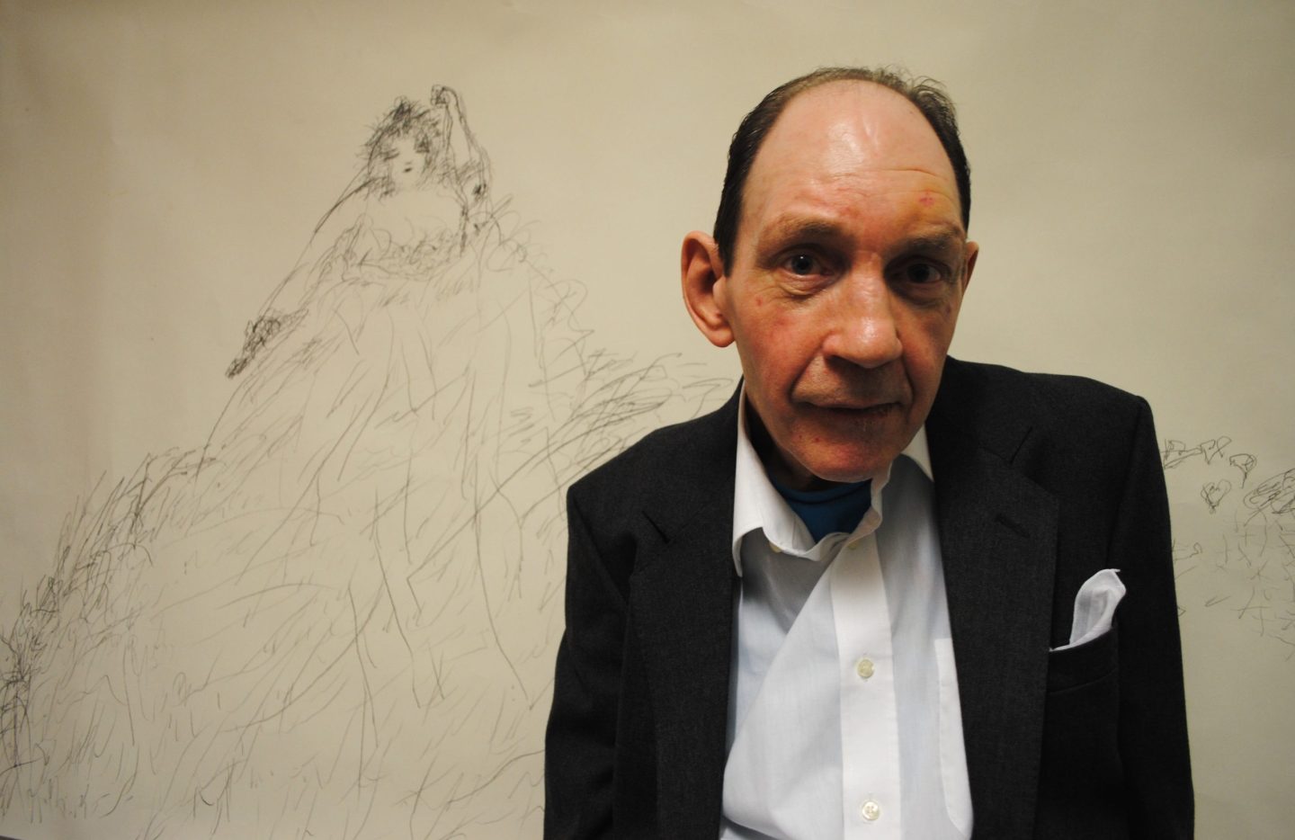 Nigel Kingsbury standing in front of one of his drawings.