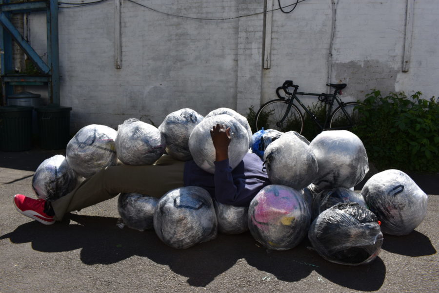 Nnena Kalu lying inside her sculpture.