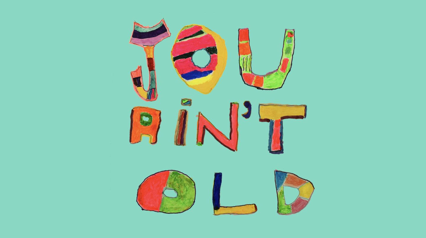 Video still from an animation reading 'you ain't old' in colourful hand written typography on a green turquoise background.