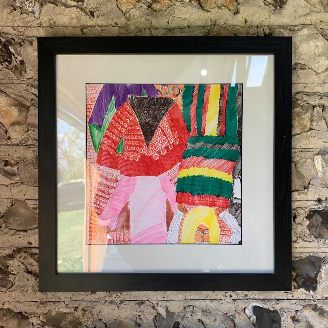 Thomas Owen's artwork in a frame. It contains colourful felt drawings of people, with small circle shapes on their clothes.