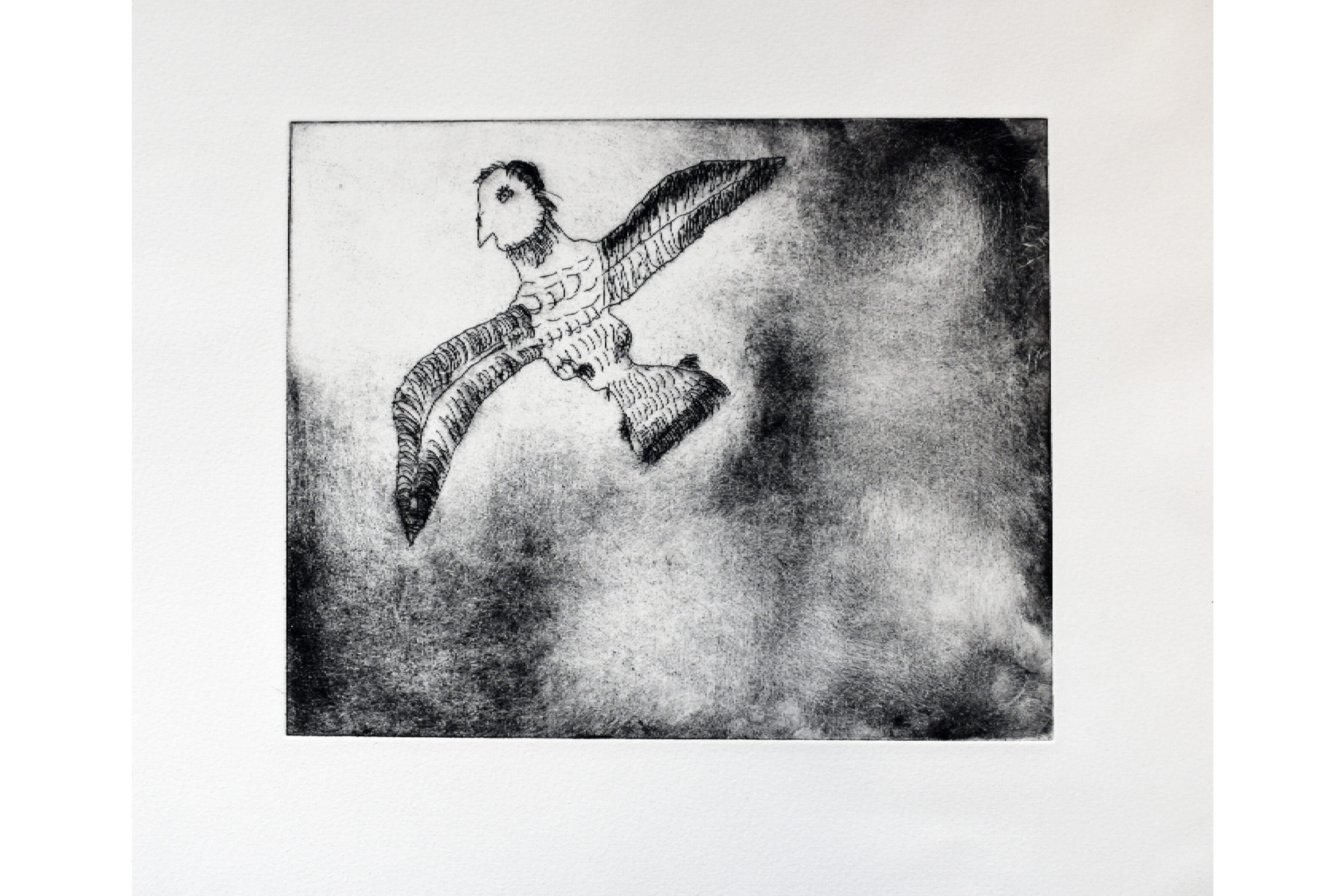 A black intaglio print of a bird with a man's head on white paper.