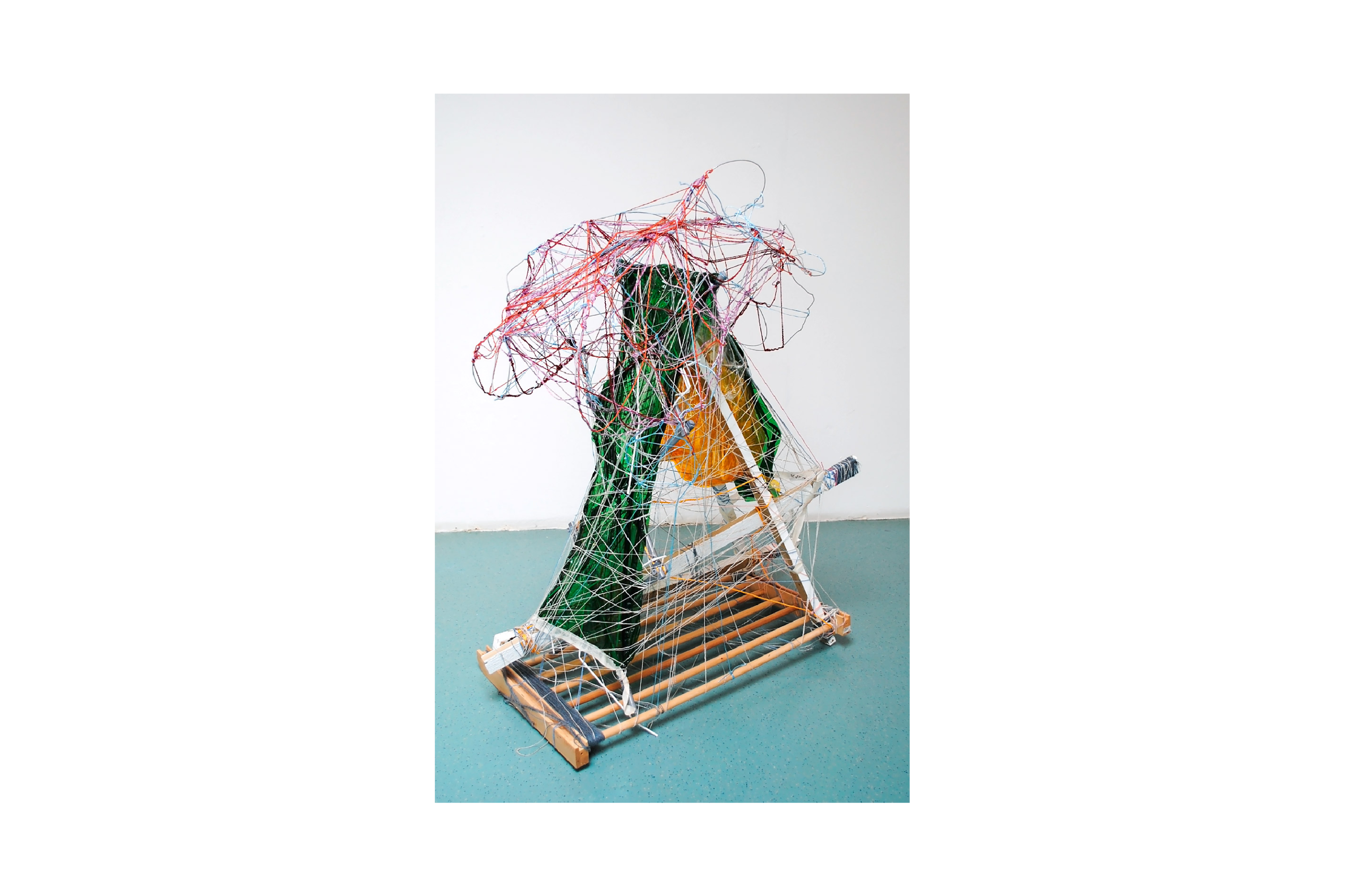 A multimedia sculpture using wire and assemblage, shaped like triangular prism.