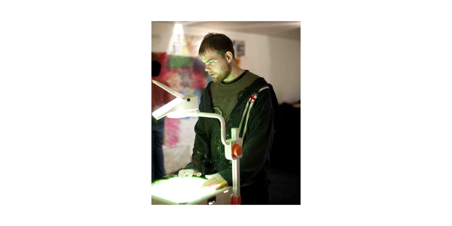 Artist Declan Leslie using an overhead projector.