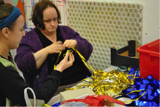 Artist Linda Bell working with volunteer Georgia