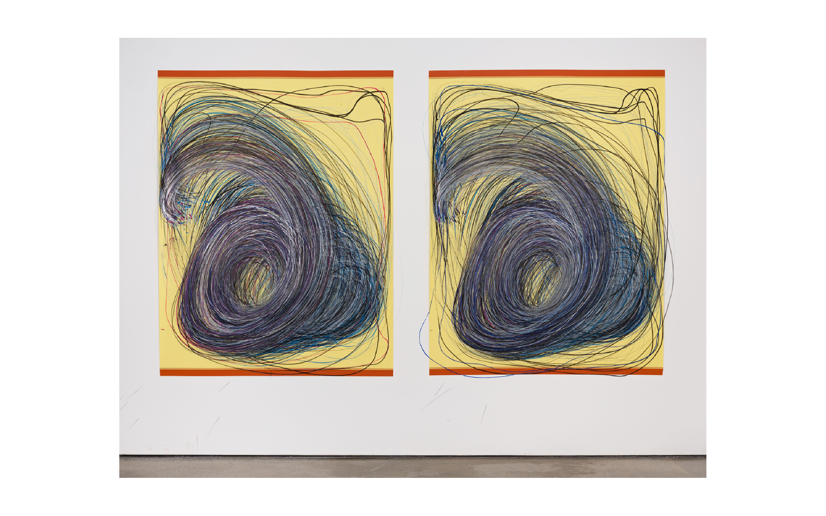 Photo of two large scale drawings by Nnena Kalu. The drawings are drawn in blue, black and purple mixed media on yellow paper. They are fixed to the wall with red tape at the top and bottom of the artworks.