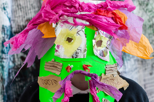 A colourful mask of a variety of different textiles.