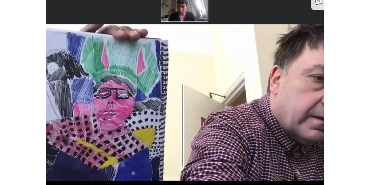 A screenshot of artist Thomas Owen holding up a drawing to the camera on Zoom.