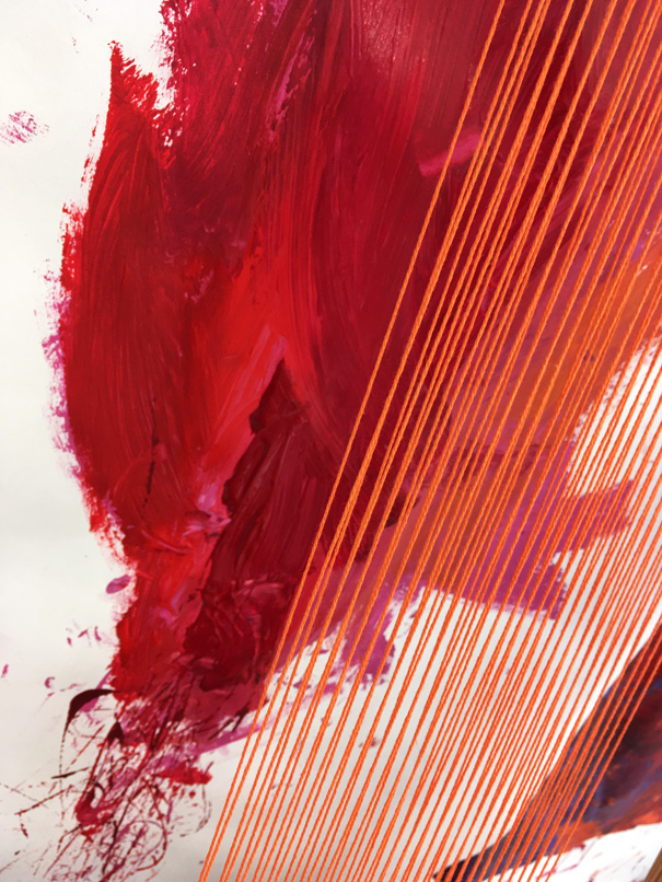 A detailed shot, showing taut orange string and dark pink brushstrokes in the background.