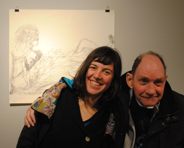 Artist Nigel Kingsbury stood with a woman in front of his artwork.