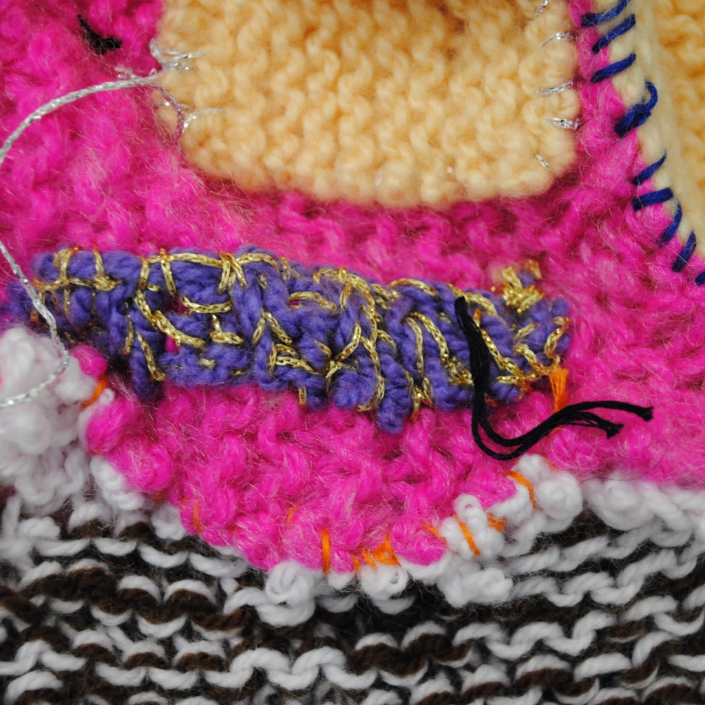 A close up shot of knitted wool, in a range of bright colours.