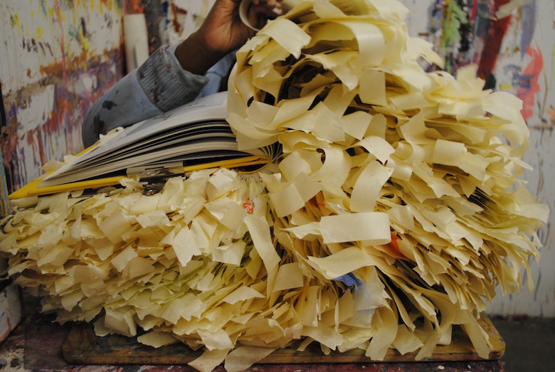 Nnena Kalu's artwork, a book with lots of strips of masking tape layered in it